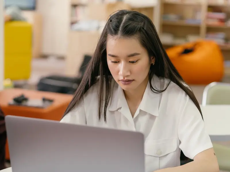 Professional using a laptop for online learning management